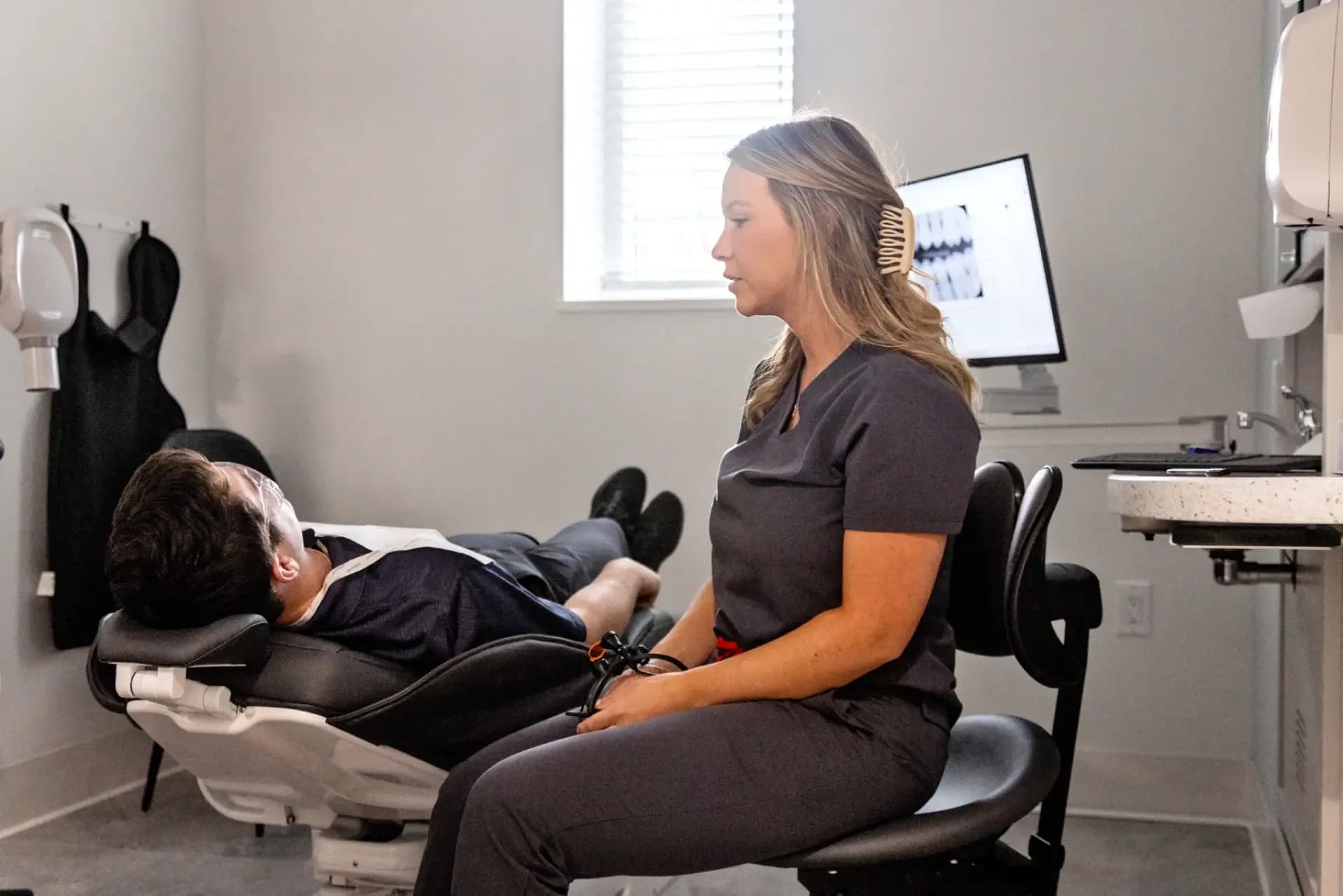Dental assistant caring for a patient during root canal treatment at Miller Dental Care in Orillia